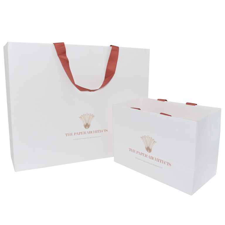 White paper shopping bags with cotton ribbon handles and printed branding